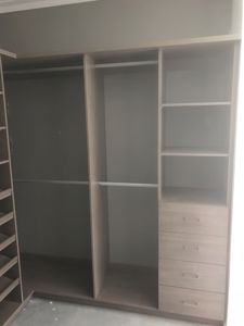 Built-In-Wardrobe-Artisan-Oak-Matt-Colour-Board-Shelving-with-Chrome-Hanging-Rods-Bank-of-Drawers-with-Polished-Silver-Handles