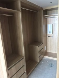 Built-In-Wardrobe-Polytec-Natural-Oak-Colour-Board-Shelving-Banks-of-Drawers-Chrome-Hanging-Rods-2