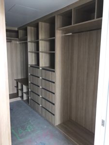 Built-In-Wardrobe-Polytec-Natural-Oak-Colour-Board-Shelving-Banks-of-Drawers-Chrome-Hanging-Rods