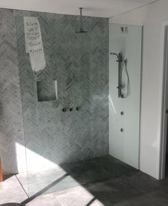 Frameless-Shower-Screen-with-Polished-Silver-Wall-Channel