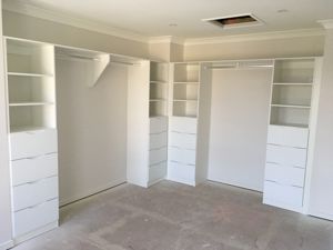 WhiteBoardBuilt-InShelvingwithBanksofDrawersandHangingRods